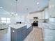 Modern kitchen with island, farmhouse sink, and granite countertops at 2613 Plyler Mill Rd, Monroe, NC 28112