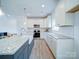 White shaker cabinets, granite countertops, and stainless steel appliances in a bright kitchen at 2613 Plyler Mill Rd, Monroe, NC 28112