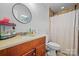 Bathroom with shower, vanity, and checkered curtain at 2909 Eastway Dr, Statesville, NC 28625