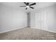 Bedroom with ceiling fan, carpet, and double doors at 2909 Eastway Dr, Statesville, NC 28625