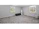 Bedroom with neutral walls, carpet, and two windows at 2909 Eastway Dr, Statesville, NC 28625