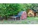 Chicken coop next to red barn in backyard at 2909 Eastway Dr, Statesville, NC 28625