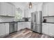 Modern kitchen with white cabinets, stainless steel appliances, and breakfast bar at 2909 Eastway Dr, Statesville, NC 28625