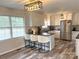 Modern kitchen with white cabinets, stainless steel appliances, and a breakfast bar at 2909 Eastway Dr, Statesville, NC 28625