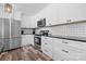 Modern kitchen with white cabinets, stainless steel appliances and breakfast bar at 2909 Eastway Dr, Statesville, NC 28625