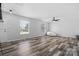 Bright living room with wood-look floors and large windows at 2909 Eastway Dr, Statesville, NC 28625