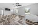 Living area with wood-look floors, large windows and TV at 2909 Eastway Dr, Statesville, NC 28625