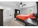 Main bedroom with large TV and orange bedding at 2909 Eastway Dr, Statesville, NC 28625