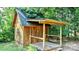 Wooden storage shed with covered porch at 2909 Eastway Dr, Statesville, NC 28625