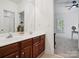 Bathroom featuring double sink vanity with wood cabinetry and a view into adjacent bedroom at 927 Dericks Xing, Fort Mill, SC 29708