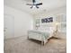 Cozy bedroom with white metal bed frame, soft carpet and natural light through shuttered windows at 927 Dericks Xing, Fort Mill, SC 29708