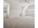 Large bonus room featuring neutral carpet, dormer ceilings, and multiple windows with shutters at 927 Dericks Xing, Fort Mill, SC 29708