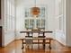 Dining area featuring hardwood floors, a rustic table with benches, and lots of natural light at 927 Dericks Xing, Fort Mill, SC 29708