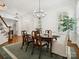Elegant dining area featuring hardwood floors, shutters, and a modern chandelier at 927 Dericks Xing, Fort Mill, SC 29708