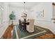 Elegant dining room featuring hardwood floors, shutters, white walls, and a modern chandelier at 927 Dericks Xing, Fort Mill, SC 29708