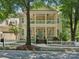 Charming two-story home with a double porch, a white picket fence, and a well-manicured front yard at 927 Dericks Xing, Fort Mill, SC 29708