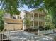 Charming two-story home with a double porch, a white picket fence, and a long driveway at 927 Dericks Xing, Fort Mill, SC 29708