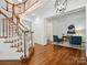 Welcoming foyer with hardwood floors, a staircase, and a glimpse into a study with blue chairs at 927 Dericks Xing, Fort Mill, SC 29708