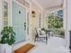 Cozy covered porch with a 'welcome' mat, stylish seating, and a view of the surrounding trees at 927 Dericks Xing, Fort Mill, SC 29708