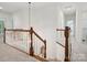Bright hallway with hardwood railing and neutral carpeting leading to other rooms at 927 Dericks Xing, Fort Mill, SC 29708