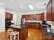 Beautiful kitchen with dark wood cabinetry, granite countertops and a functional center island at 927 Dericks Xing, Fort Mill, SC 29708