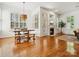 Open living and dining room area with hardwood floors, fireplace, and lots of windows at 927 Dericks Xing, Fort Mill, SC 29708