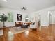 Bright living room with hardwood floors, comfortable seating, and natural light from the windows at 927 Dericks Xing, Fort Mill, SC 29708