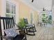 Covered front porch featuring rocking chairs, overhead fan and view of the greenery at 927 Dericks Xing, Fort Mill, SC 29708
