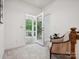 Sunroom with open doors to the porch, chair and ample natural light at 927 Dericks Xing, Fort Mill, SC 29708
