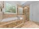 Elegant bathroom with a soaking tub, tile shower, and neutral tones at 160 Northington Woods Dr, Mooresville, NC 28117