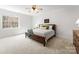 Cozy bedroom with plush carpeting, ceiling fan, and natural light from the window at 160 Northington Woods Dr, Mooresville, NC 28117