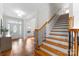 Bright foyer featuring tile flooring, elegant staircase, and a view into the adjacent living space at 160 Northington Woods Dr, Mooresville, NC 28117