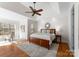 Bright main bedroom features a tray ceiling, ceiling fan, and a large window seat offering natural light at 160 Northington Woods Dr, Mooresville, NC 28117