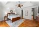 Spacious main bedroom with decorative wall mirror, ceiling fan and wood flooring at 160 Northington Woods Dr, Mooresville, NC 28117