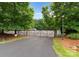 Gated entrance to the boat storage area in a wooded lot, offering secure storage for boats and watercraft at 160 Northington Woods Dr, Mooresville, NC 28117