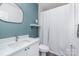 Charming bathroom featuring a vanity, a toilet, and a tub with a white shower curtain at 12229 Savannah Garden Dr, Charlotte, NC 28273