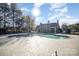 Community pool surrounded by mature trees and clear blue skies, perfect for relaxation and recreation at 12229 Savannah Garden Dr, Charlotte, NC 28273