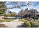 Inviting community pool area with lush greenery, a picnic table, and a well-maintained walkway at 12229 Savannah Garden Dr, Charlotte, NC 28273