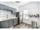 Bright kitchen featuring stainless steel appliances, grey cabinets, mosaic backsplash, and a window at 12229 Savannah Garden Dr, Charlotte, NC 28273