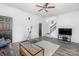 Inviting living room with hardwood floors, a ceiling fan and staircase leading to the second floor at 12229 Savannah Garden Dr, Charlotte, NC 28273