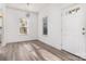 Bright living room with hardwood floors, two windows and a white front door at 12229 Savannah Garden Dr, Charlotte, NC 28273