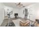 Cozy living room with hardwood floors, ceiling fan, and adjacent dining area. The stairs are visible at 12229 Savannah Garden Dr, Charlotte, NC 28273