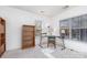 Well-lit office space with two windows, wood bookcase, black desk, and a green chair at 12229 Savannah Garden Dr, Charlotte, NC 28273