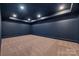 Finished basement area offers neutral carpet and a painted blue ceiling and walls at 626 Concord Rd, Davidson, NC 28036