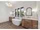 Elegant bathroom with a soaking tub, double vanities, and large windows offering natural light at 626 Concord Rd, Davidson, NC 28036
