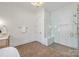 Bathroom featuring a spacious walk-in shower with glass doors and stylish tiling at 626 Concord Rd, Davidson, NC 28036
