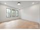 Bedroom with light colored wood floors and large windows providing natural light at 626 Concord Rd, Davidson, NC 28036