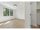 Bright bedroom features hardwood floors, black framed windows, and an adjacent walk-in closet at 626 Concord Rd, Davidson, NC 28036