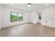 Bright bedroom features hardwood floors, two windows, and white walls and trim at 626 Concord Rd, Davidson, NC 28036