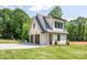 A carriage house with two-car garage, side entry door, and lawn at 626 Concord Rd, Davidson, NC 28036